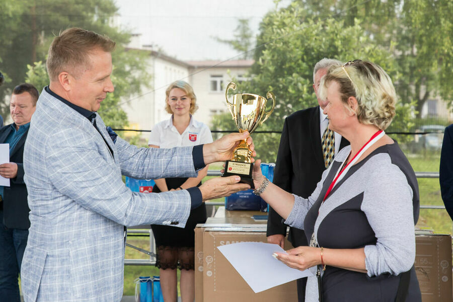 Zastępca wójta przekazuje puchar zawodniczce