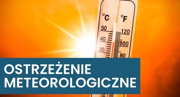 Termometr wskazujący wysoką temperaturę w otoczeniu jaskrawego słońca. Na zdjęciu widnieje napis "Ostrzeżenie meteorologiczne", sugerujący upał lub gorące warunki pogodowe.