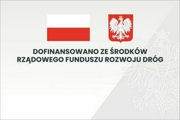 Zdjęcie przedstawia grafikę z polską flagą po lewej stronie i godłem Polski po prawej. Poniżej napis: "Dofinansowano ze środków Rządowego Funduszu Rozwoju Dróg".