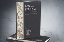 Zdjęcie przedstawia trzy ułożone na sobie książki o tematyce historycznej związane z Powiatem Lubelskim, z tytułem "Spacerem przez wieki" na górze w tle.