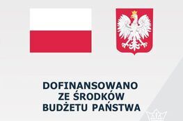 Zdjęcie przedstawia grafikę z flagą Polski po lewej stronie i godłem Polski po prawej. Poniżej napis "DOFINANSOWANO ZE ŚRODKÓW BUDŻETU PAŃSTWA" na białym tle.