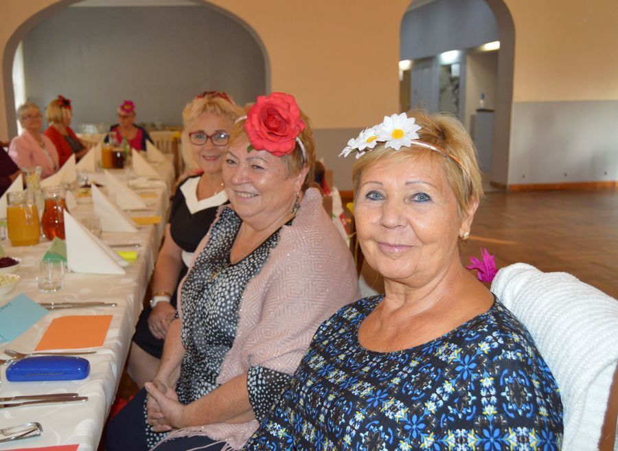 Na zdjęciu Seniorki z Klubu Senior+ siedzą przy stole w sali Metalowiec.