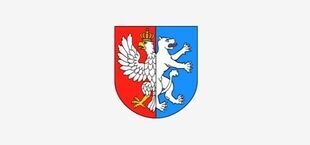 Herb przedstawia dwie połówki: po lewej biały orzeł w złotej koronie na czerwonym tle, po prawej biały niedźwiedź na niebieskim tle. Tarcza podzielona jest pionowo na dwie części.