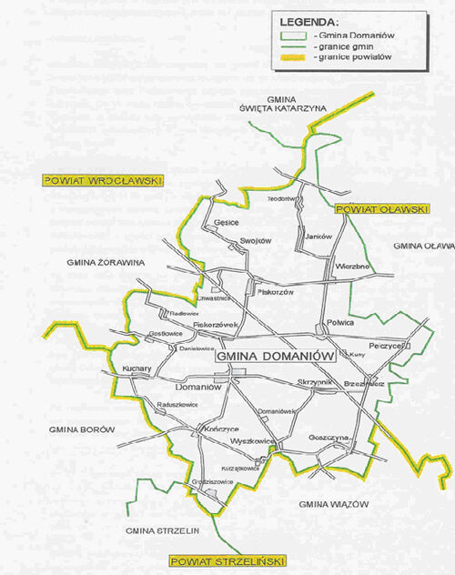 Mapa administracyjna z wyraźnie zaznaczonymi granicami gminy Domaniów, otoczona innymi gminami, z oznaczeniami dróg i miejscowości.