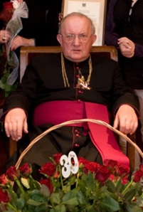 Fotografia przedstawia ks. kan. Bolesława Nowaka z kwiatami.
