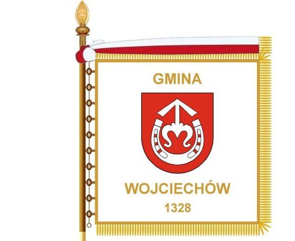 Flaga z herbem Gminy Wojciechów, z czerwonym tłem, białym orłem, dwoma srebrnymi mieczami i datą 1328, obramowana złotą frędzlą.